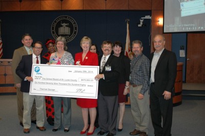 The St. Lucie County School Board was presented a rebate check in the amount of nearly $680,000